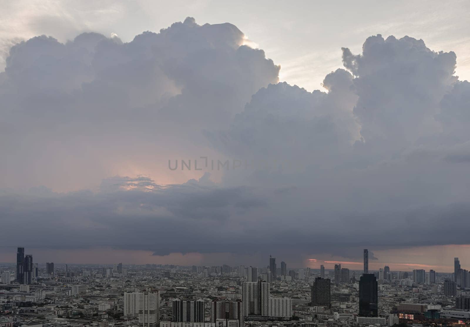Bangkok, Thailand - 28 May 2024 - Beautiful clouds in the sky over large metropolitan city of bangkok. Aerial view of skyscrapers and dramatic sky before sunset, Copy space, Selective focus.