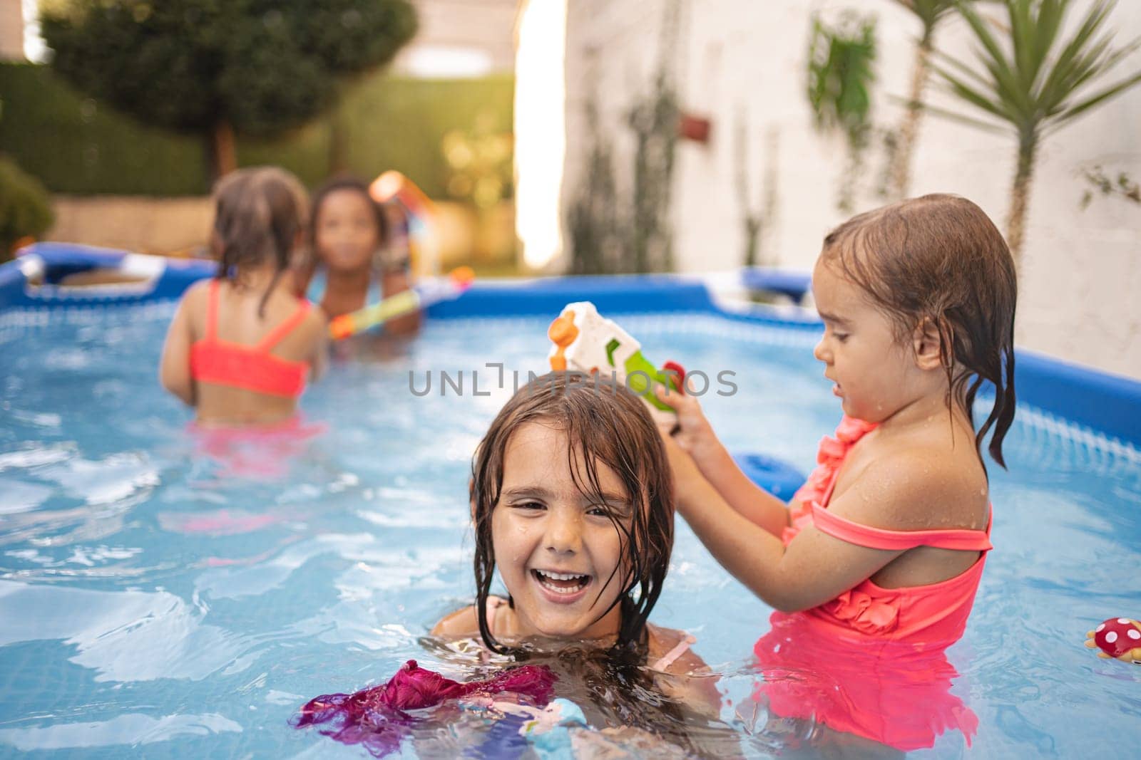 Kids are having fun splashing water and enjoying summer activities.
