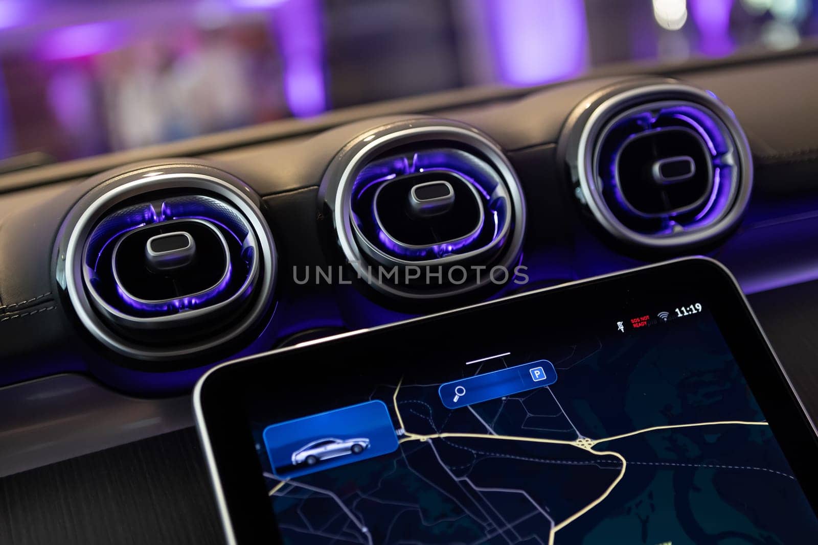 Close-up of a luxury car's interior dashboard, showcasing advanced technology and design with stylish air vents.