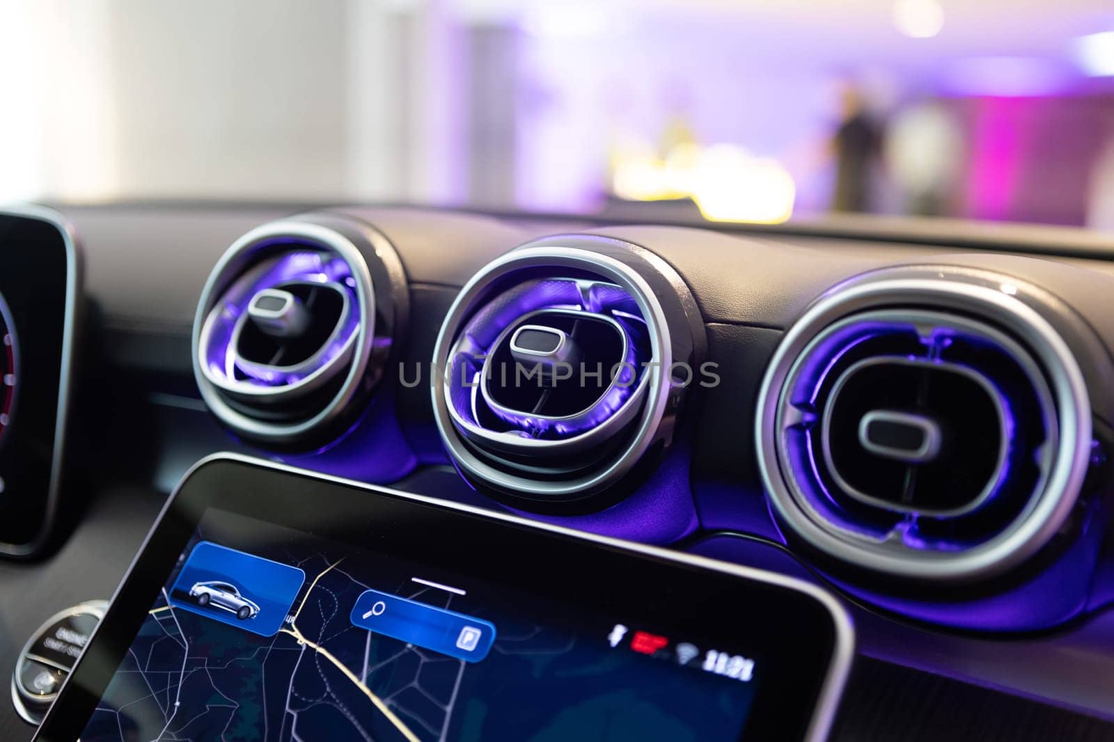 Close-up of a luxury car's interior dashboard, showcasing advanced technology and design with stylish air vents.