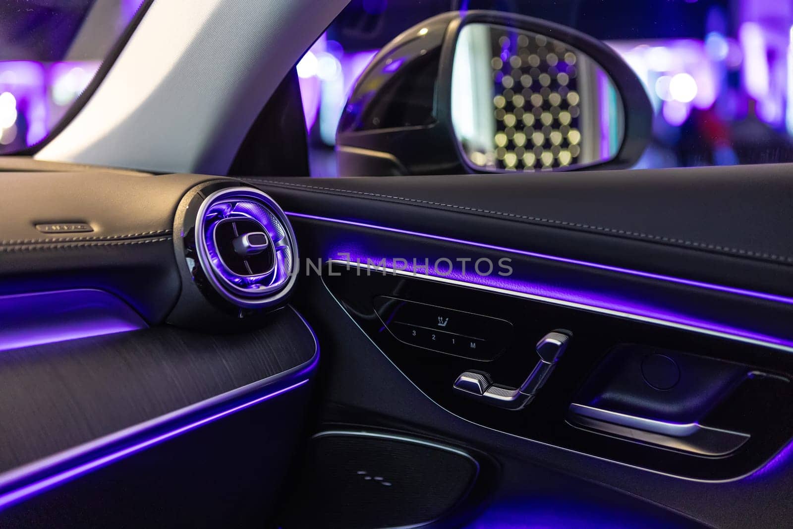 Luxury car interior featuring ambient lighting, sleek design, and premium materials