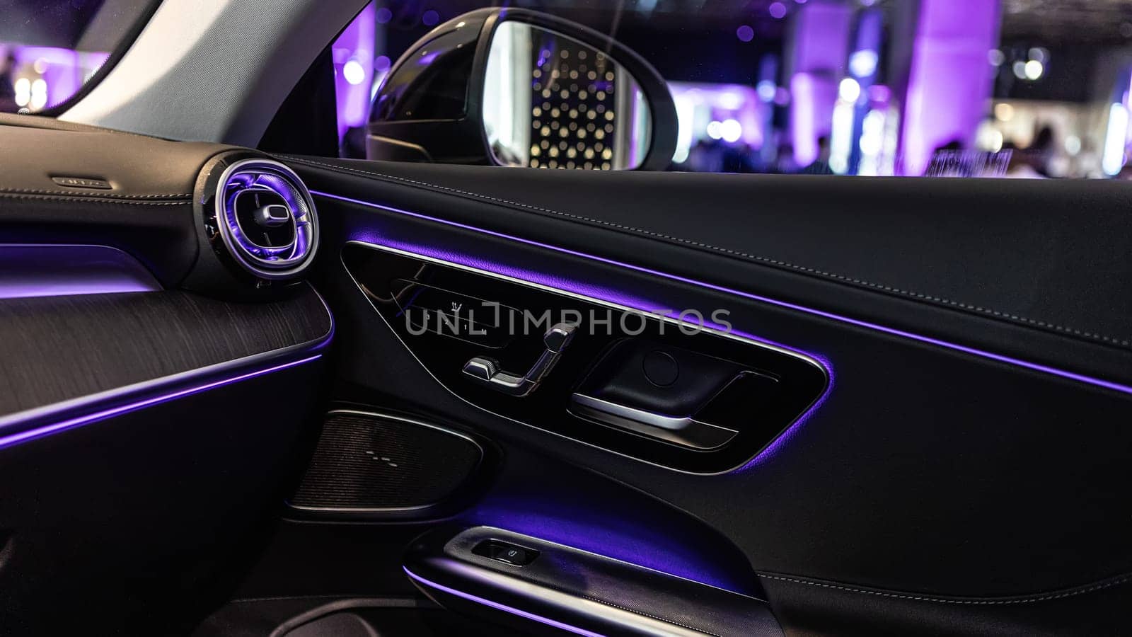Luxury car interior featuring ambient lighting, sleek design, and premium materials