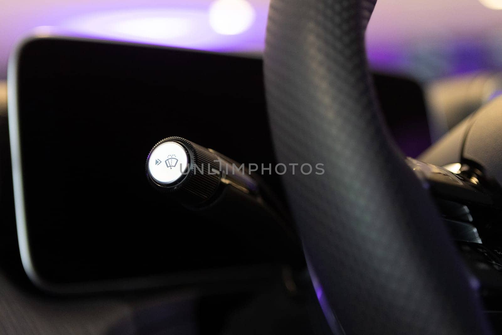 Close-up of a luxury car windshield wiper control lever, showcasing the sleek design and modern technology