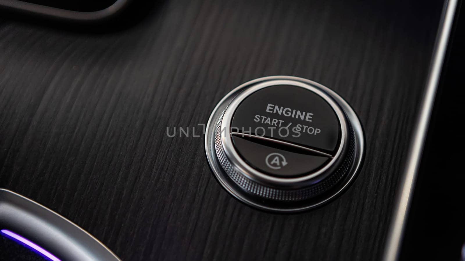Pressing Stand By Power Button To Turn On and Off the Electric Car Close-Up. Push start stop button of ev car. Finger press the button to start the car engine. Concept of transportation and technology