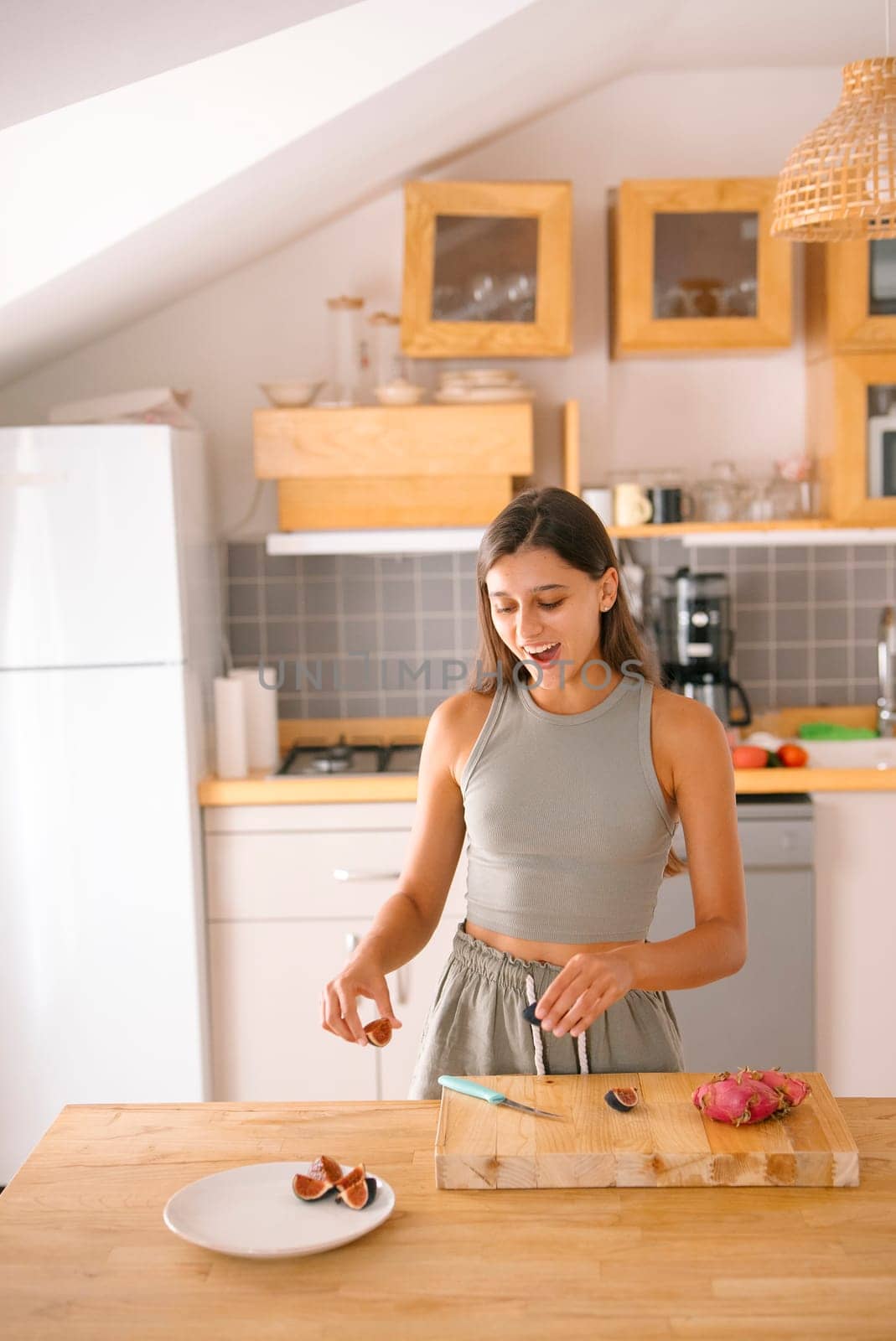 A joyful woman enthusiastically prepares a healthy and delicious snack in her stylish, modern kitchen venue