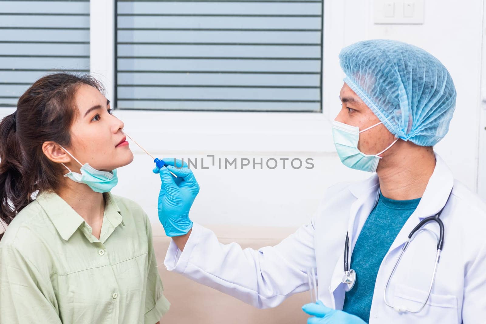 Coronavirus test, Doctor man take saliva sample through nose with cotton swab to check coronavirus test from Asian young woman, Covid-19 pandemic outbreak Medicine And Health Care Concept