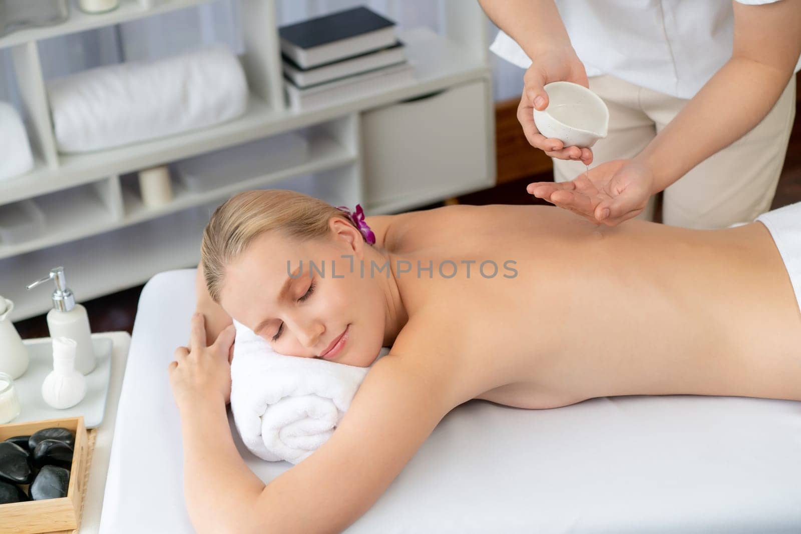 Masseuse prepare oil massage procedure for customer at spa. Quiescent by biancoblue