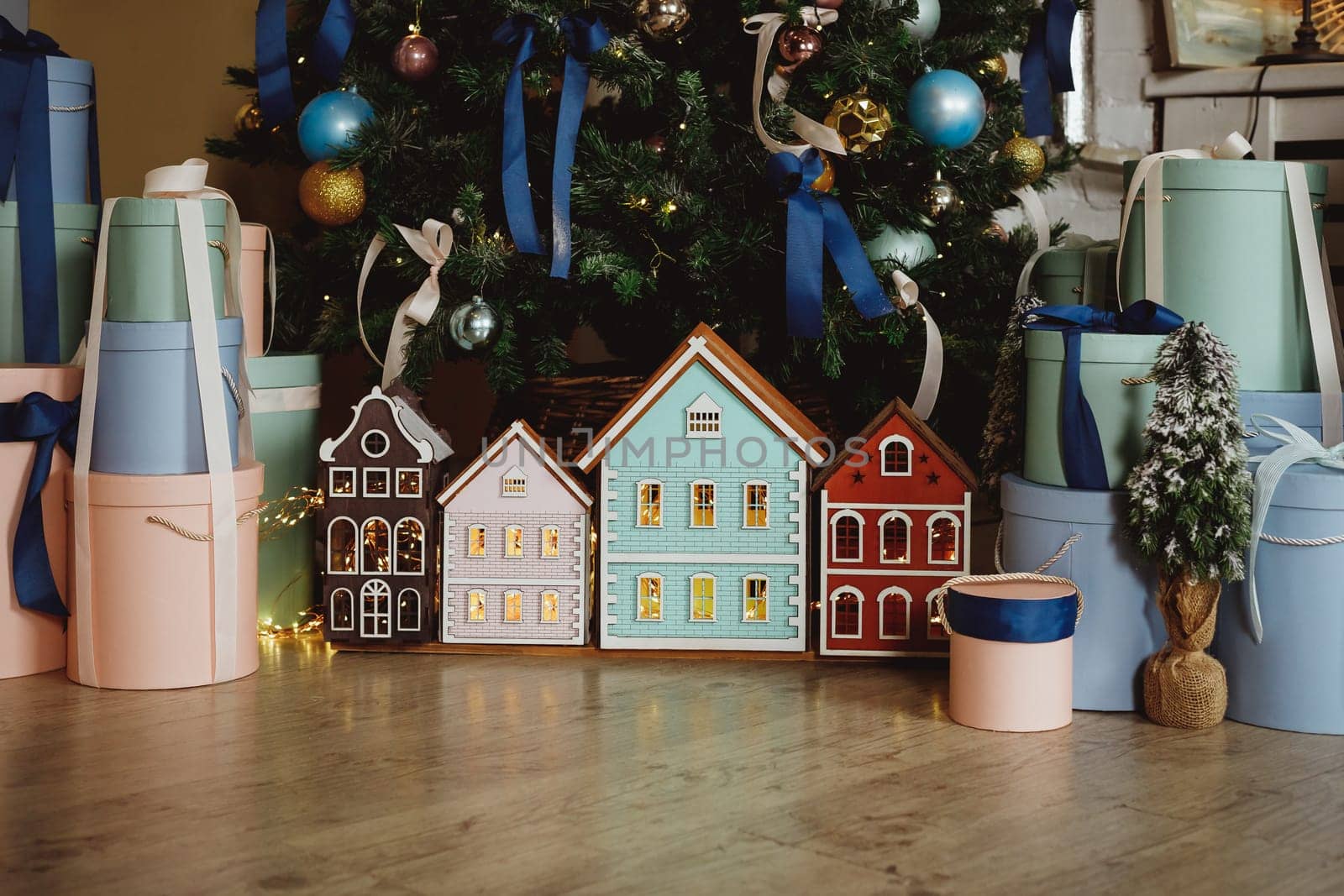 Gift boxes under the Christmas tree close-up. Gifts near the Christmas tree in blue and white paper.