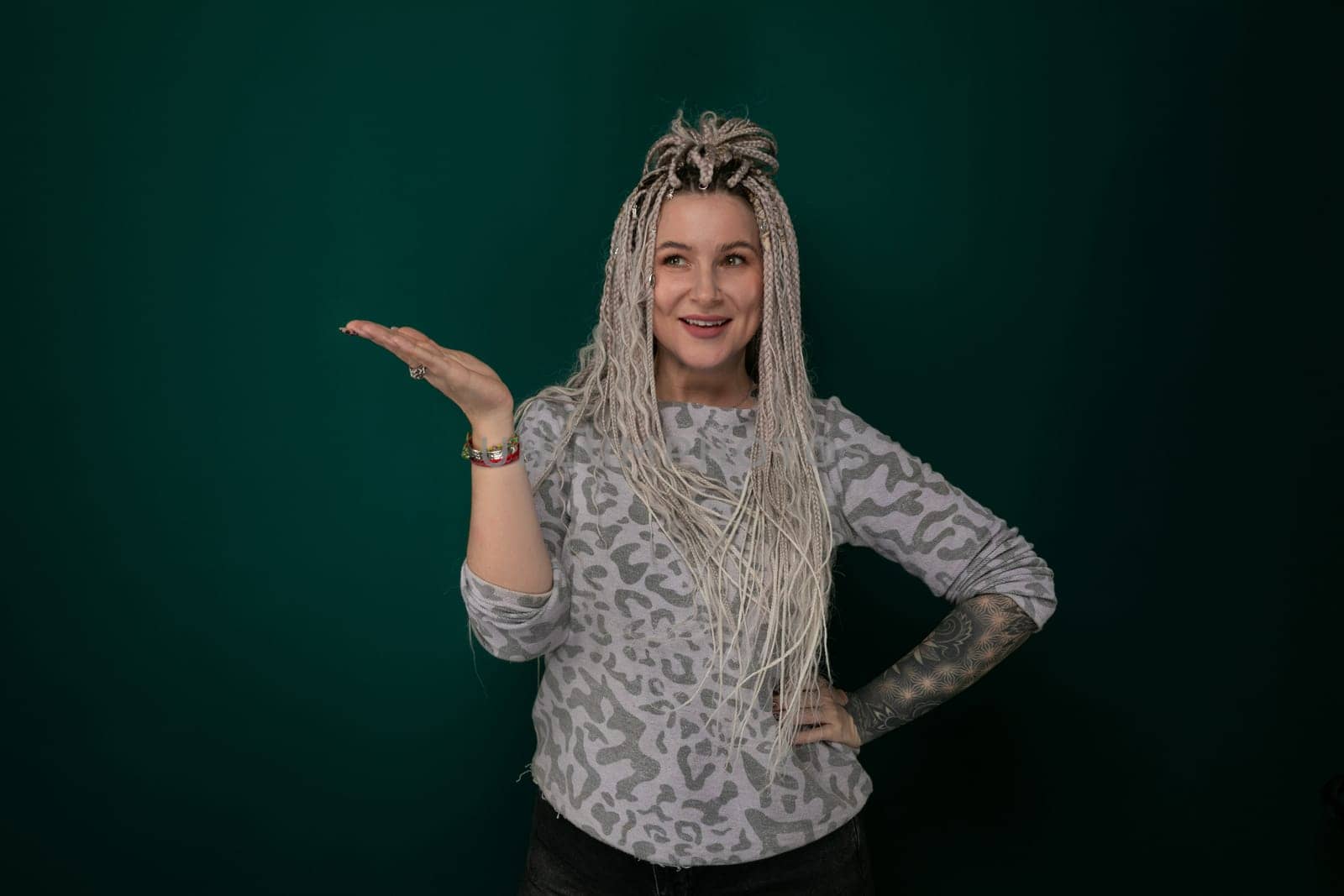 A woman with long hair is striking a pose for a picture. She is standing confidently and looking directly at the camera, showcasing her flowing hair and elegant posture.