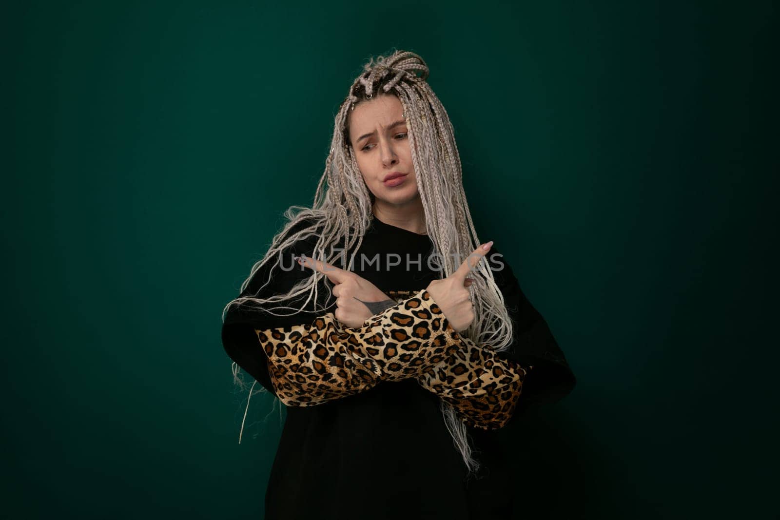 A woman with long flowing hair stands confidently holding a stylish leopard print purse. Her hair cascades down her shoulders as she showcases the trendy accessory.