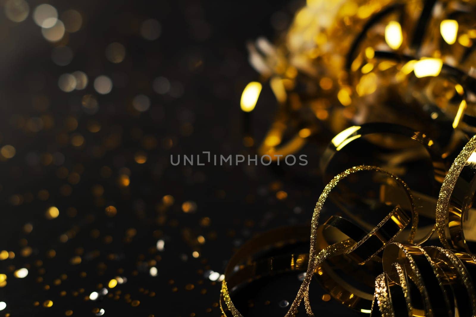 Confetti and ribbons create a festive celebration with sparkle, glitter, and gold bokeh for a shiny party