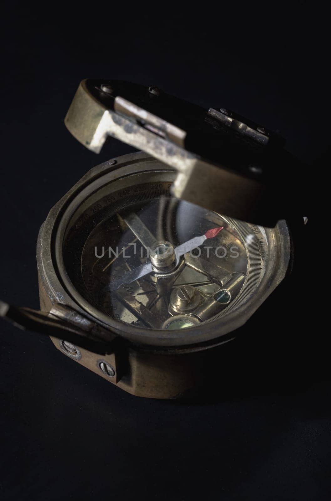 Bangkok, Thailand - 18 Sep, 2024 - Antique bronze emblem compass (Old compass) on dark background. Light and Shadow, Space for text, Selective focus.