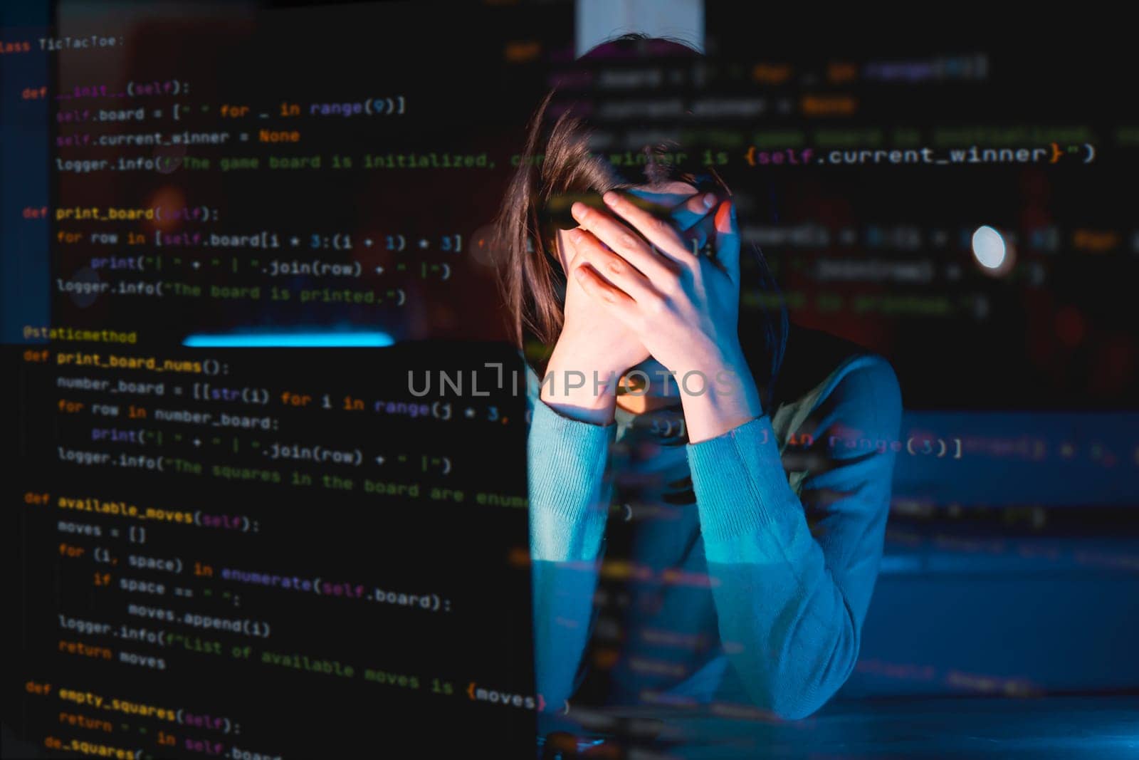 Young girl hides her face with hands, works on a laptop late at night online, a tired woman is coding and overworked, using her device to create a new project and e-learning, getting an IT education.