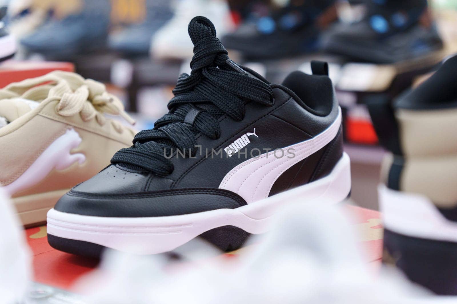 Tyumen, Russia-August 11, 2024: Stylish athletic shoe Puma displayed in a retail store with a modern design and vibrant colors