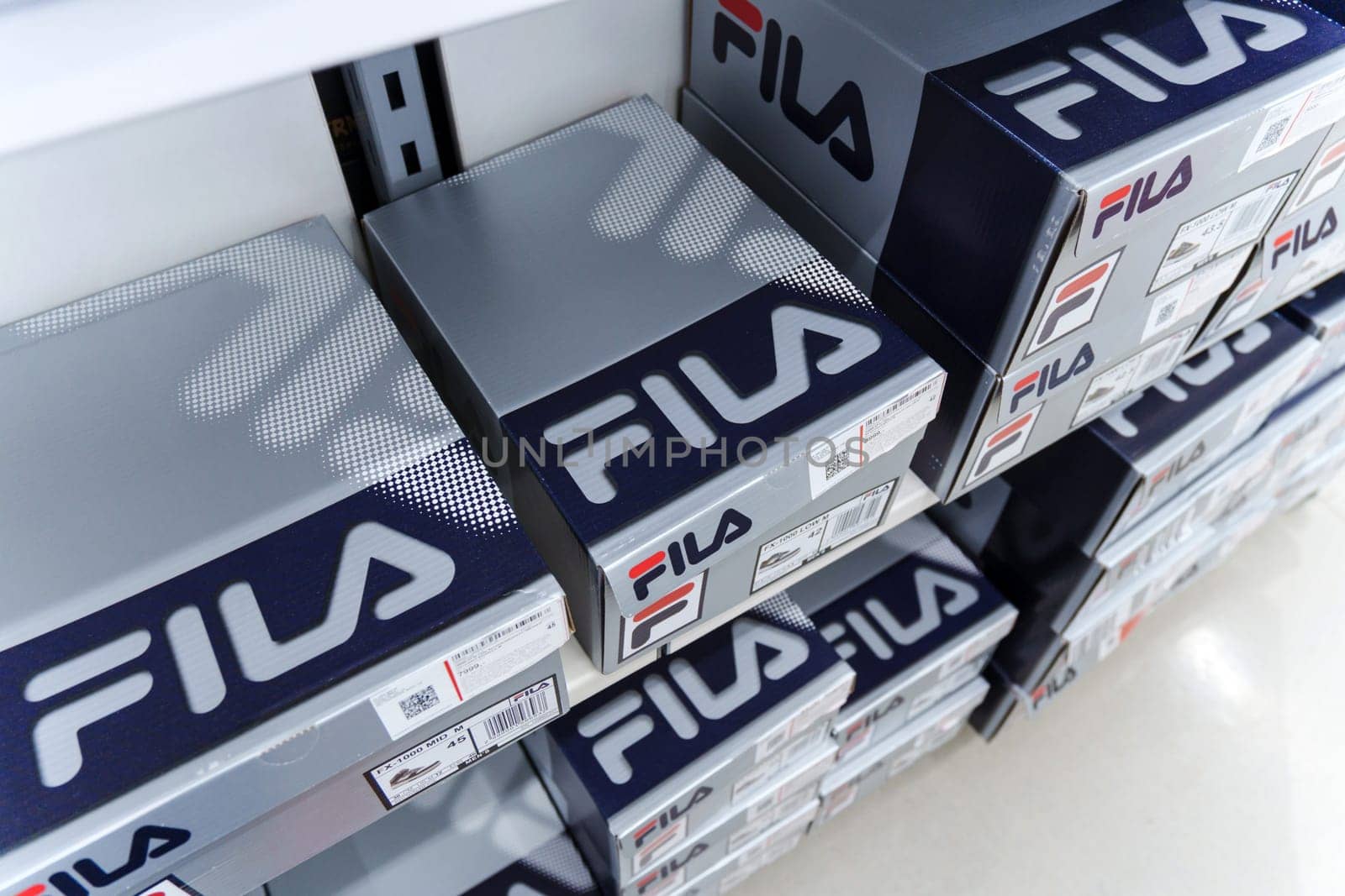 Tyumen, Russia-August 11, 2024: Fila sneaker is prominently displayed with detailed lacing and a visible brand tag, viewed inside a retail shop.