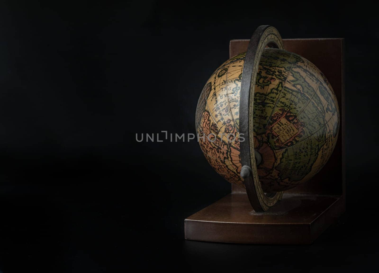 Replica Globe or World Globe Map on dark background. Unique Geography Earth Globe Home Decor, Light and Shadow, Space for text, Selective focus.
