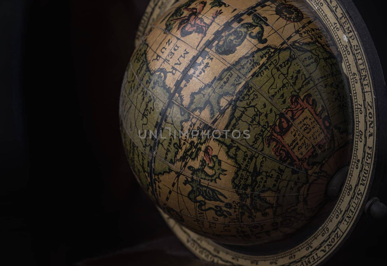 Bangkok, Thailand - 19 Sep, 2024 - Close-up of Replica Globe or World Globe Map on black background. Unique Geography Earth Globe Home Decor, Light and Shadow, Copy space, Selective focus.