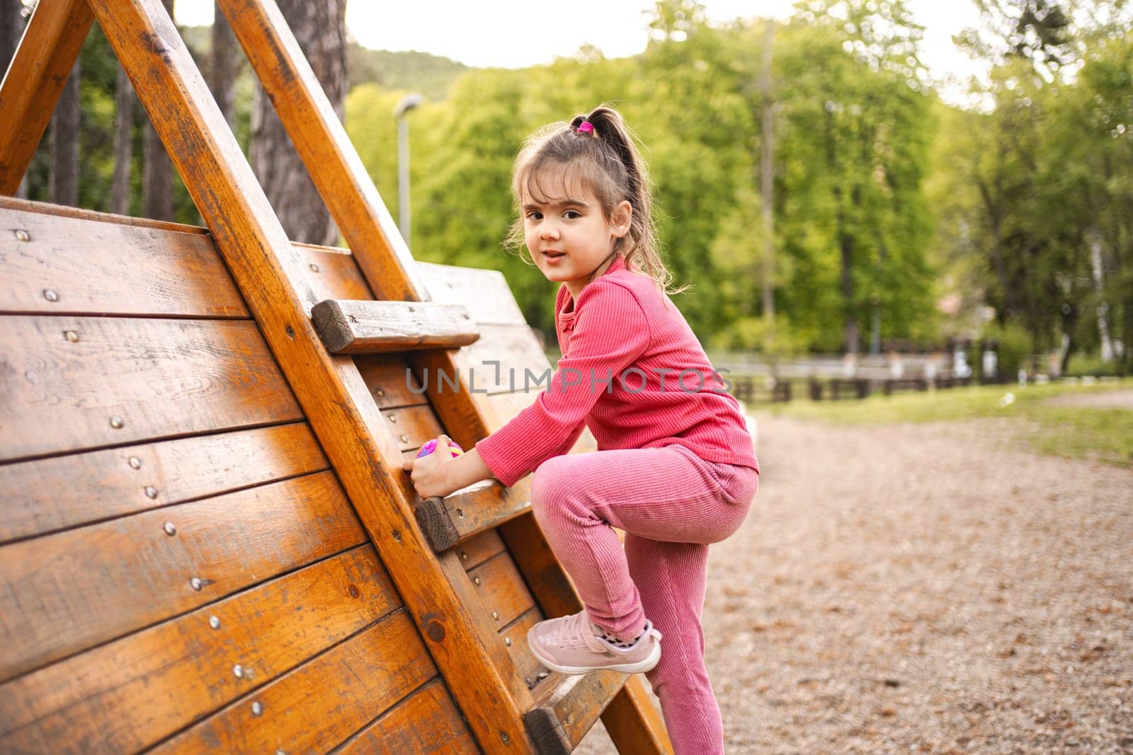 Active cute little girl on the playground.