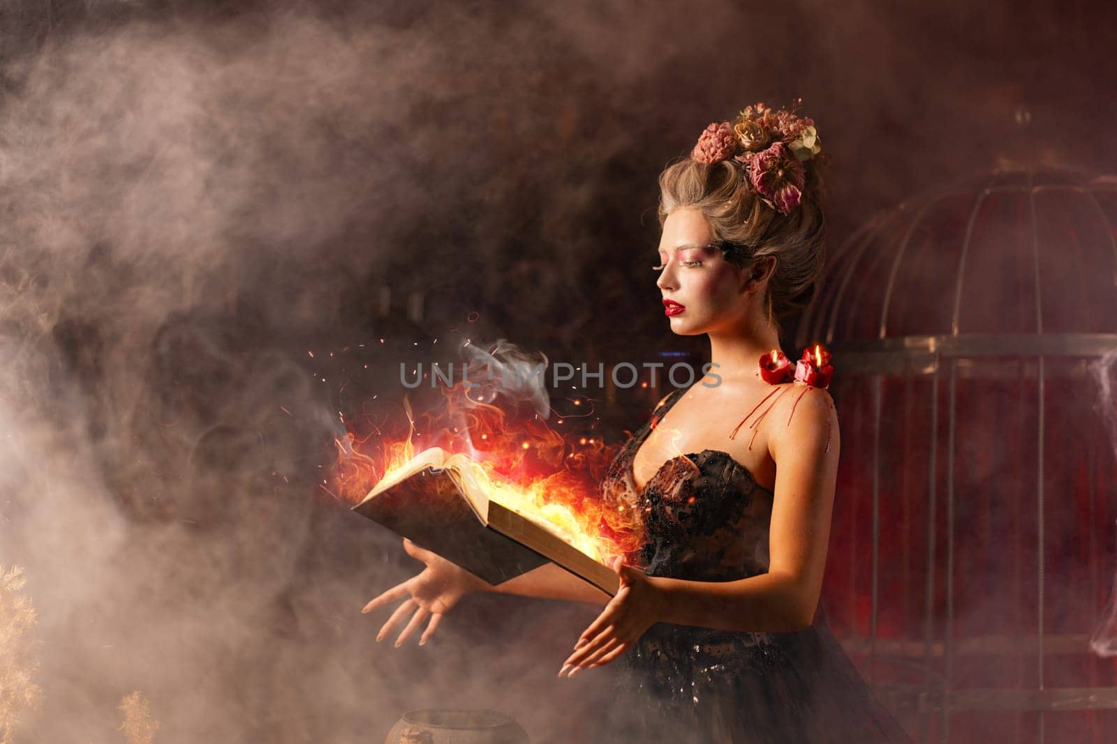 Woman witch in vintage black dress with book of spell in old castle. Halloween. Celebration. Witchcraft concept, fairy tale mystic atmosphere. Conjure magic spells.