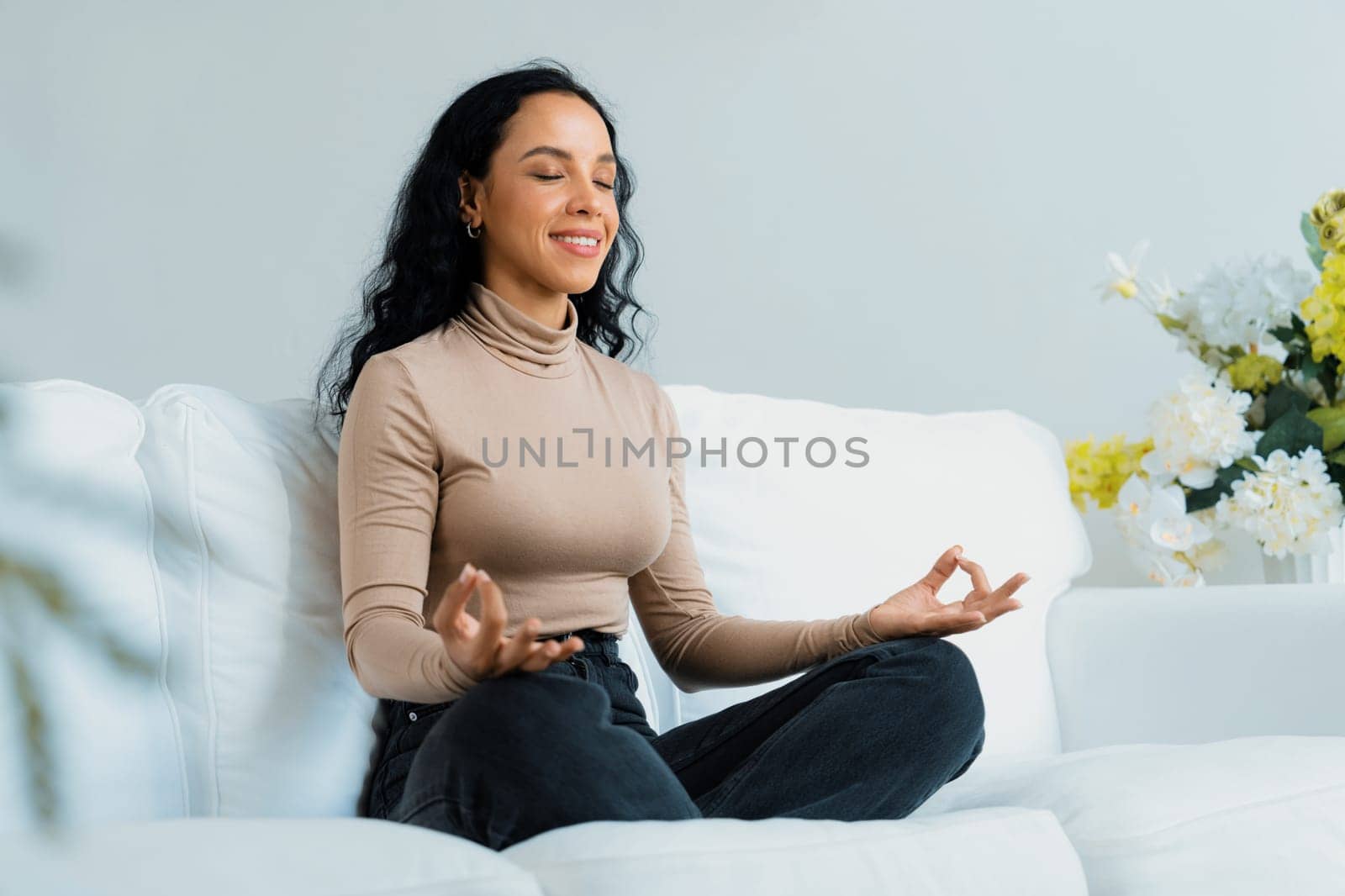 Young African American woman practice crucial mindful meditation at home living room for improving mental health strength and peaceful beautiful living