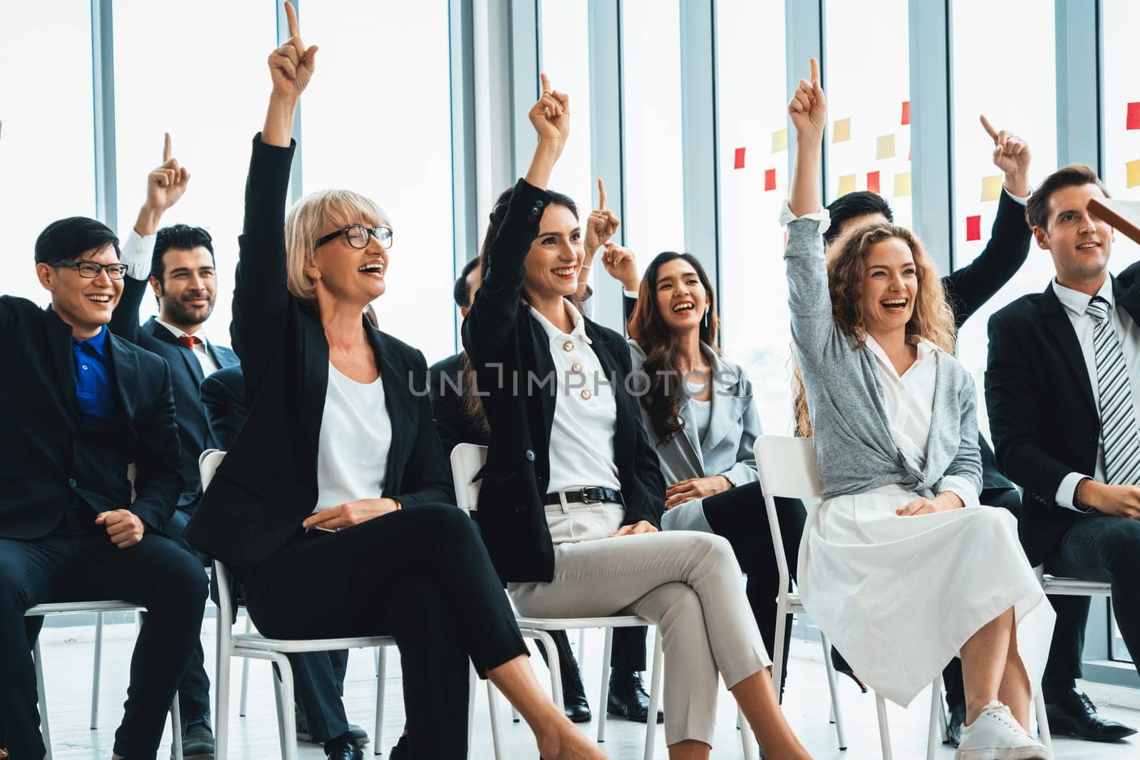 Group of business people meeting in a seminar conference . Audience listening to instructor in employee education training session . Office worker community summit forum with expert speaker . Jivy