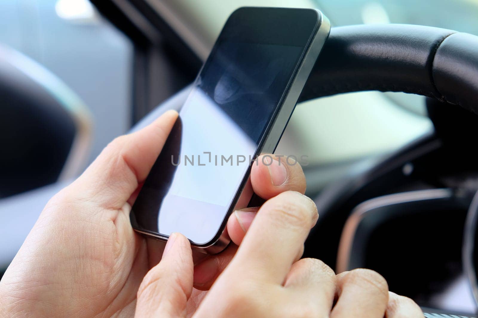 image of using a mobile phone inside of a car