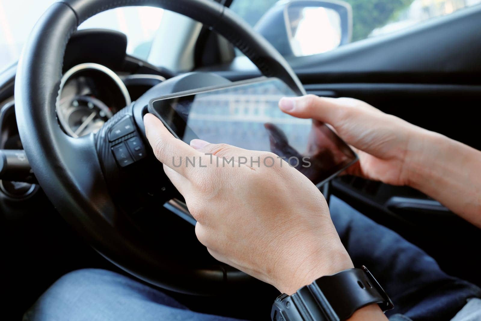 business man Sitting in the Car and Using digital tablet. by ponsulak