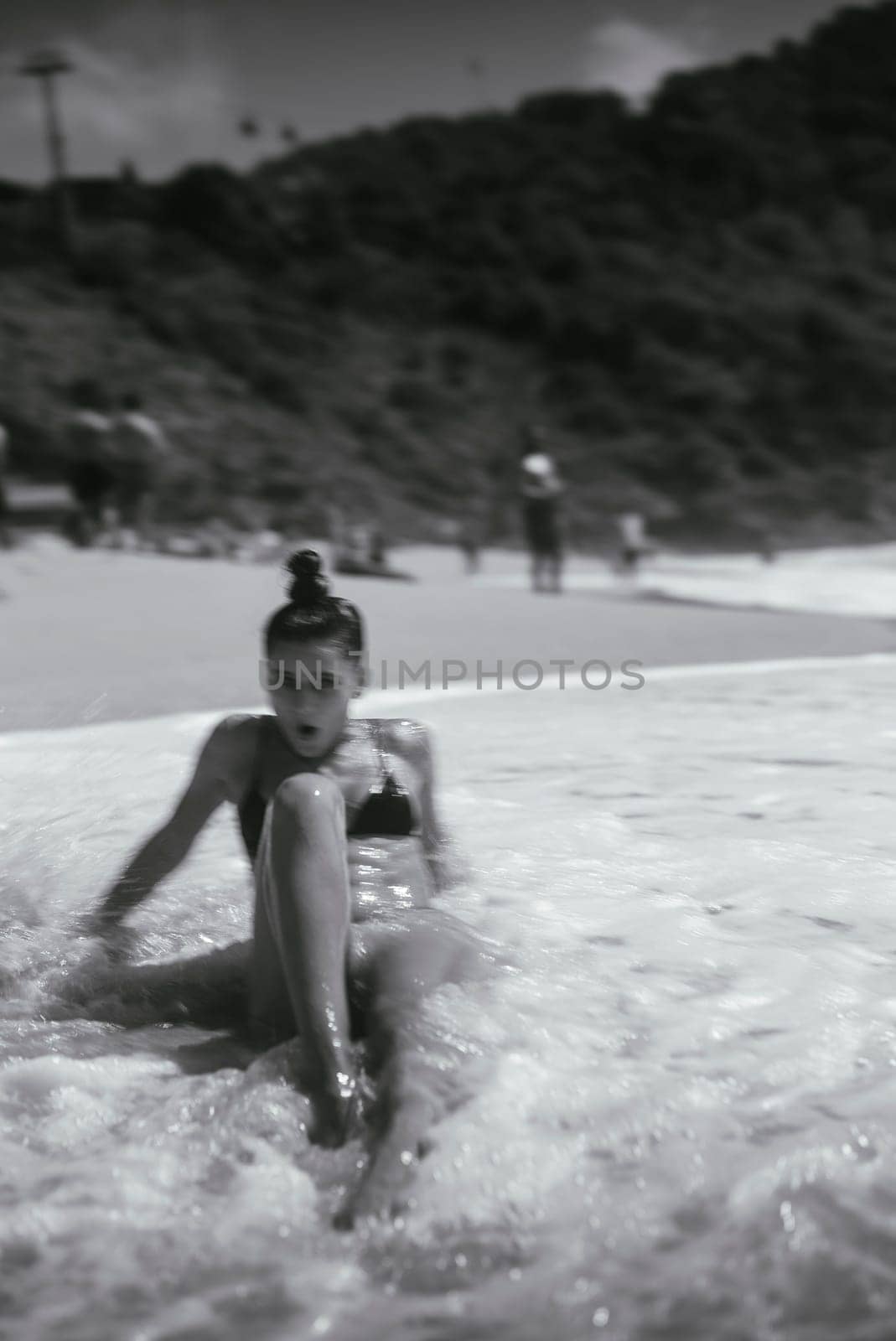 A captivating blackandwhite shot of a woman who is truly enjoying a peaceful and tranquil beach day