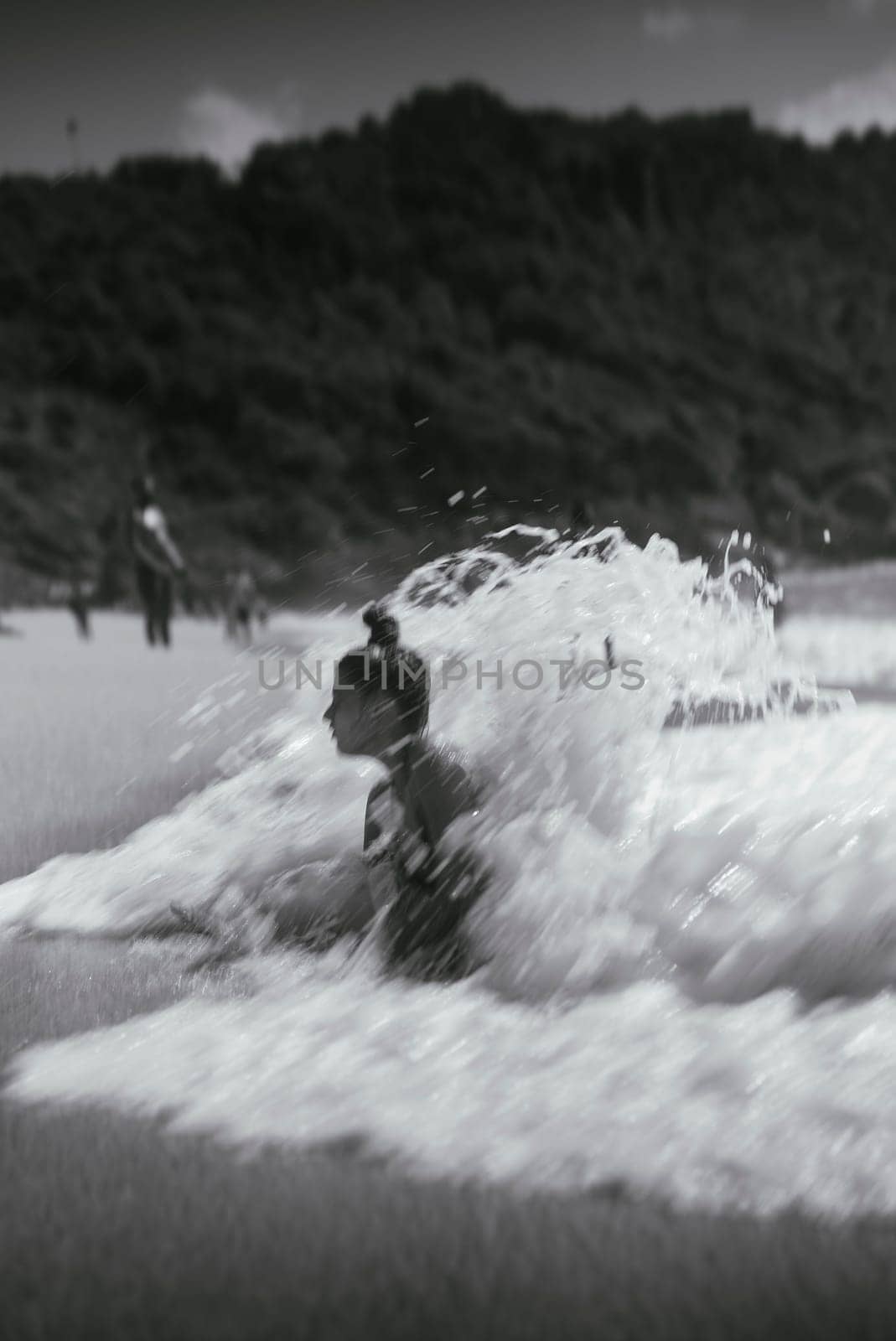 Waves crash energetically at the beach, creating an exhilarating moment that beautifully evokes nostalgia and thrill