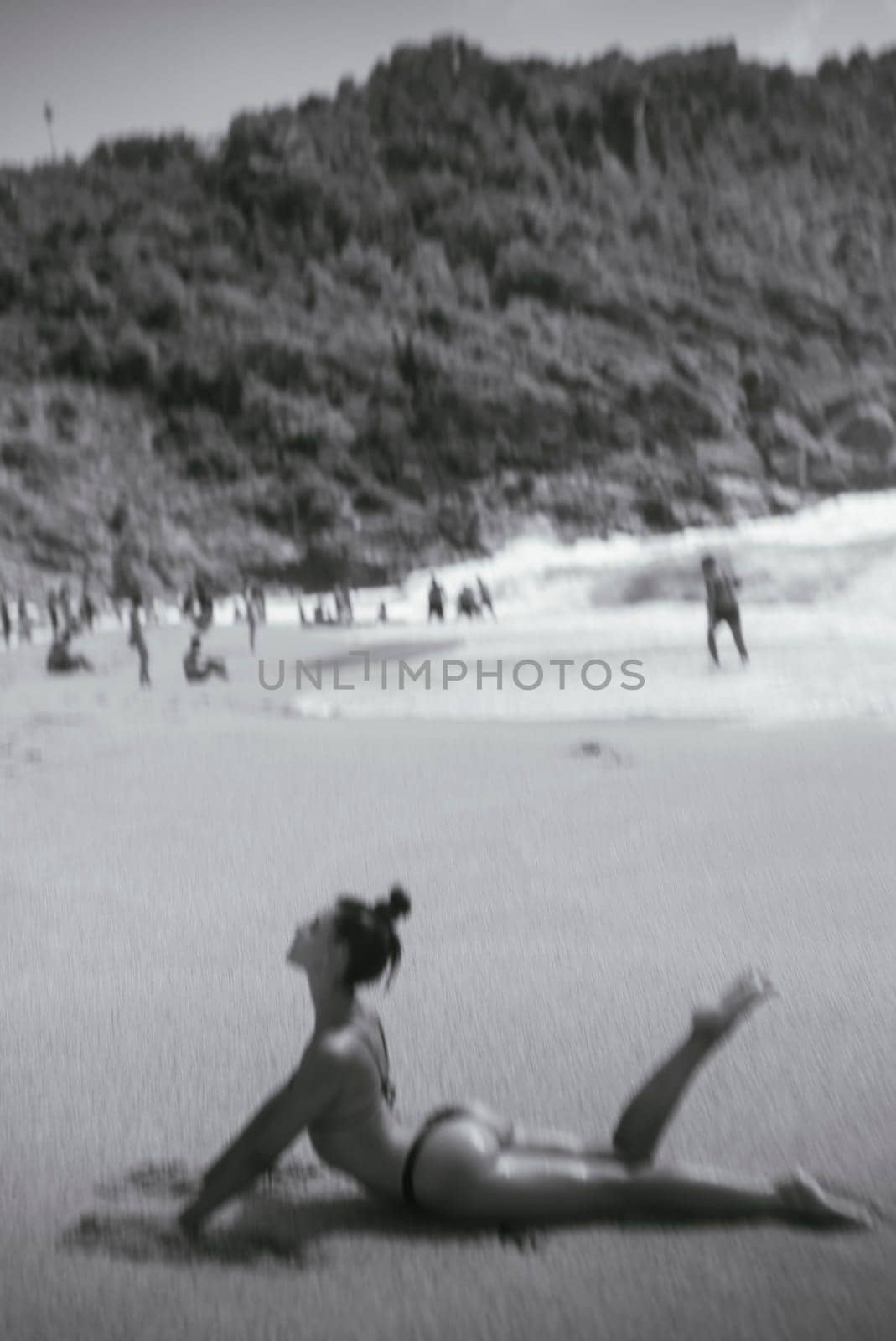 A picture of a relaxing beach scene showcases a serene pose through the artistry of black and white photography