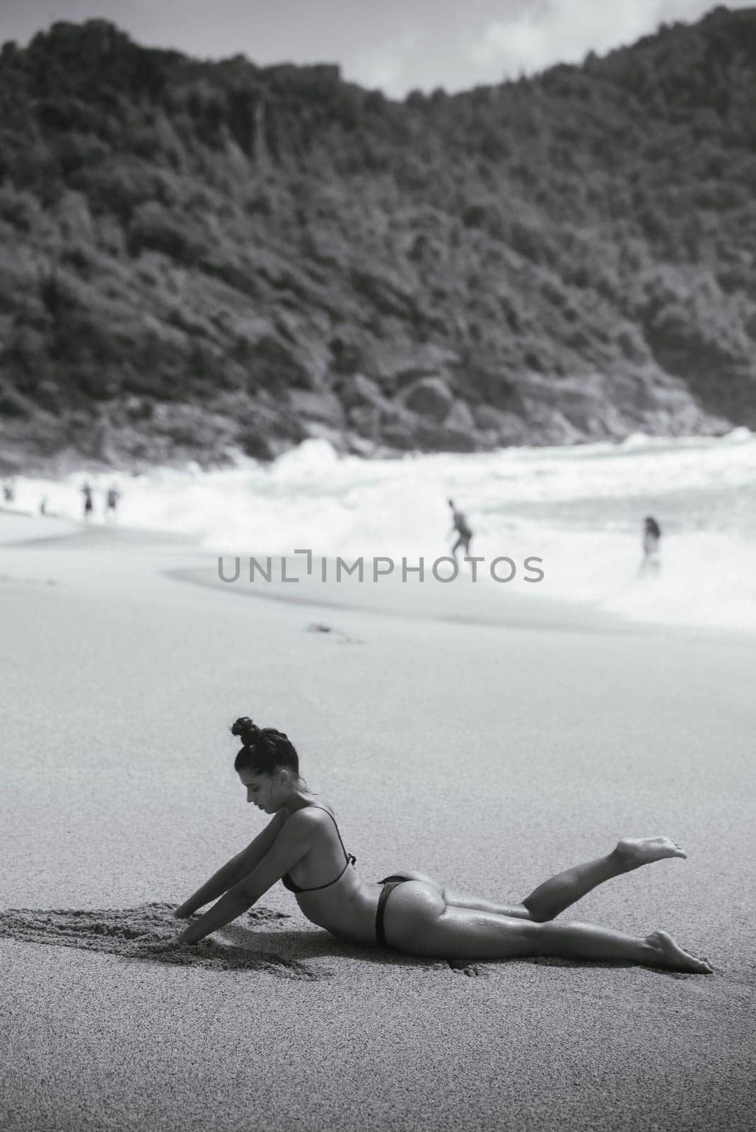A beautiful and serene beach scene captures a woman stretching, embodying relaxation and the essence of natural beauty