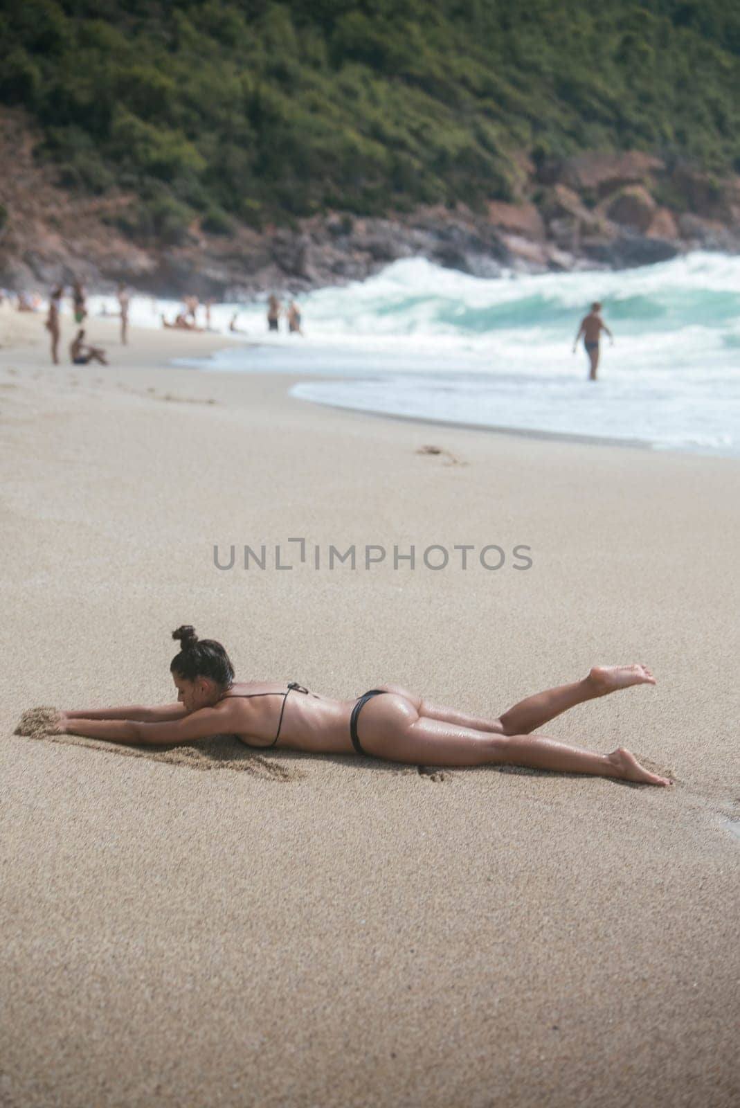 A serene scene capturing a sunbather blissfully lounging on the beach, enjoying natures wonders around her