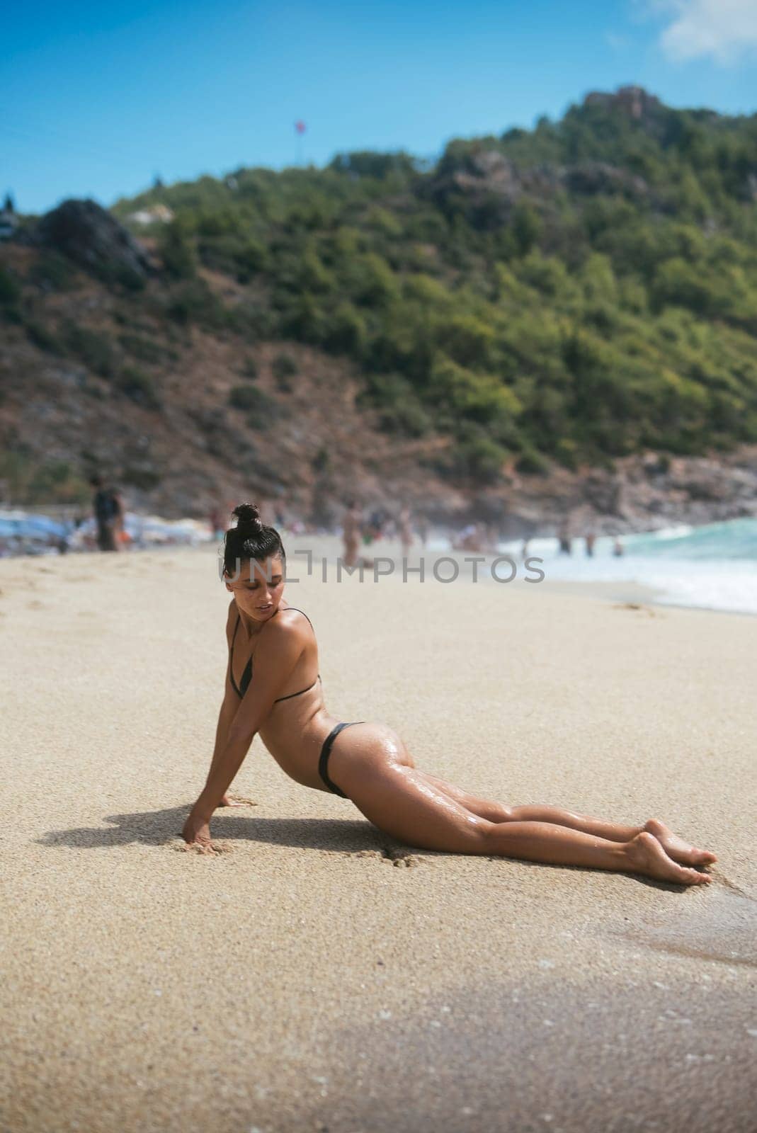 A stunning model elegantly poses on the beach, beautifully capturing the essence of summer vibes and elegance