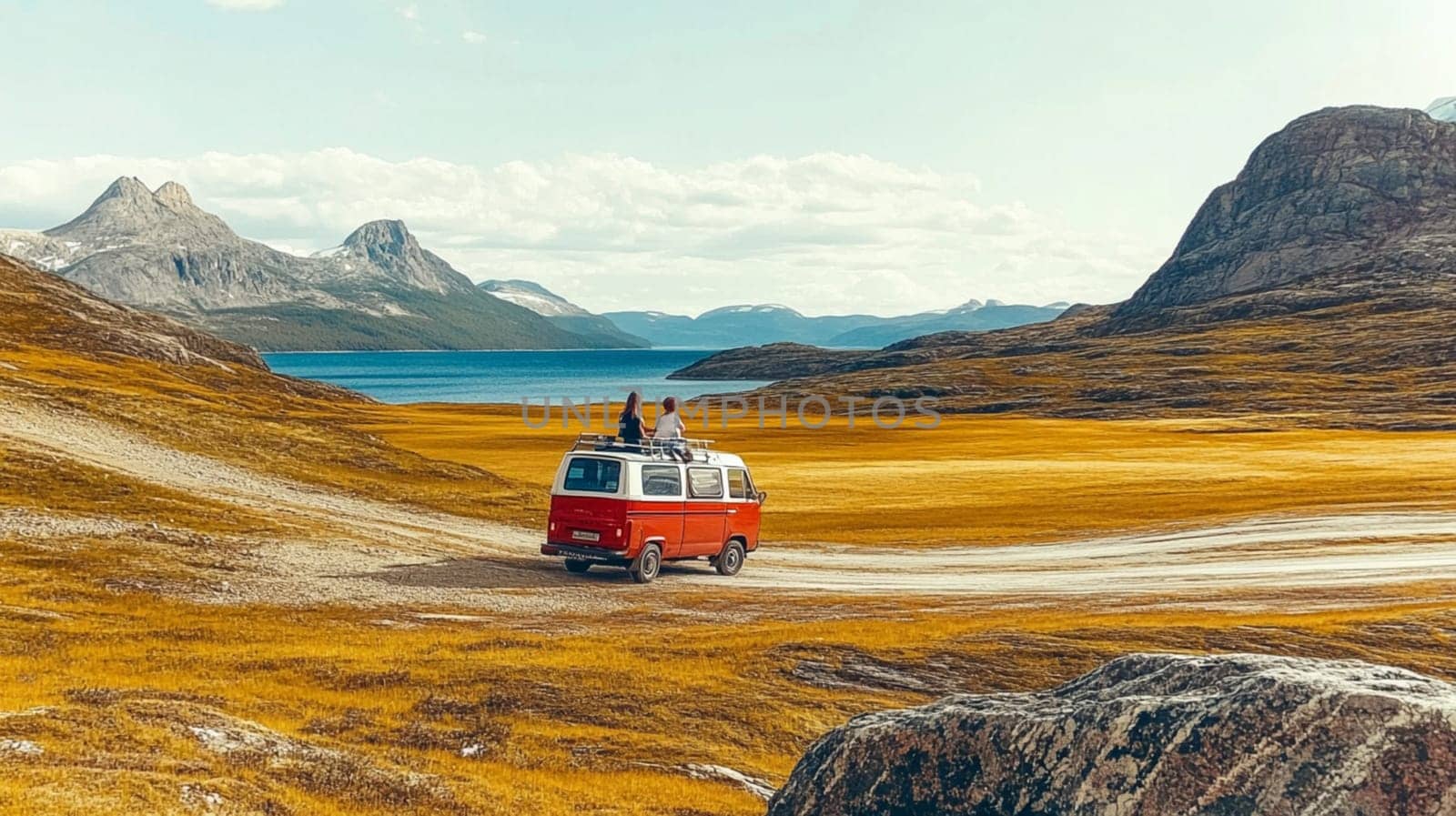 Two individuals in a car, admiring stunning ocean views as the sun sets, creating a warm and picturesque atmosphere on their journey.