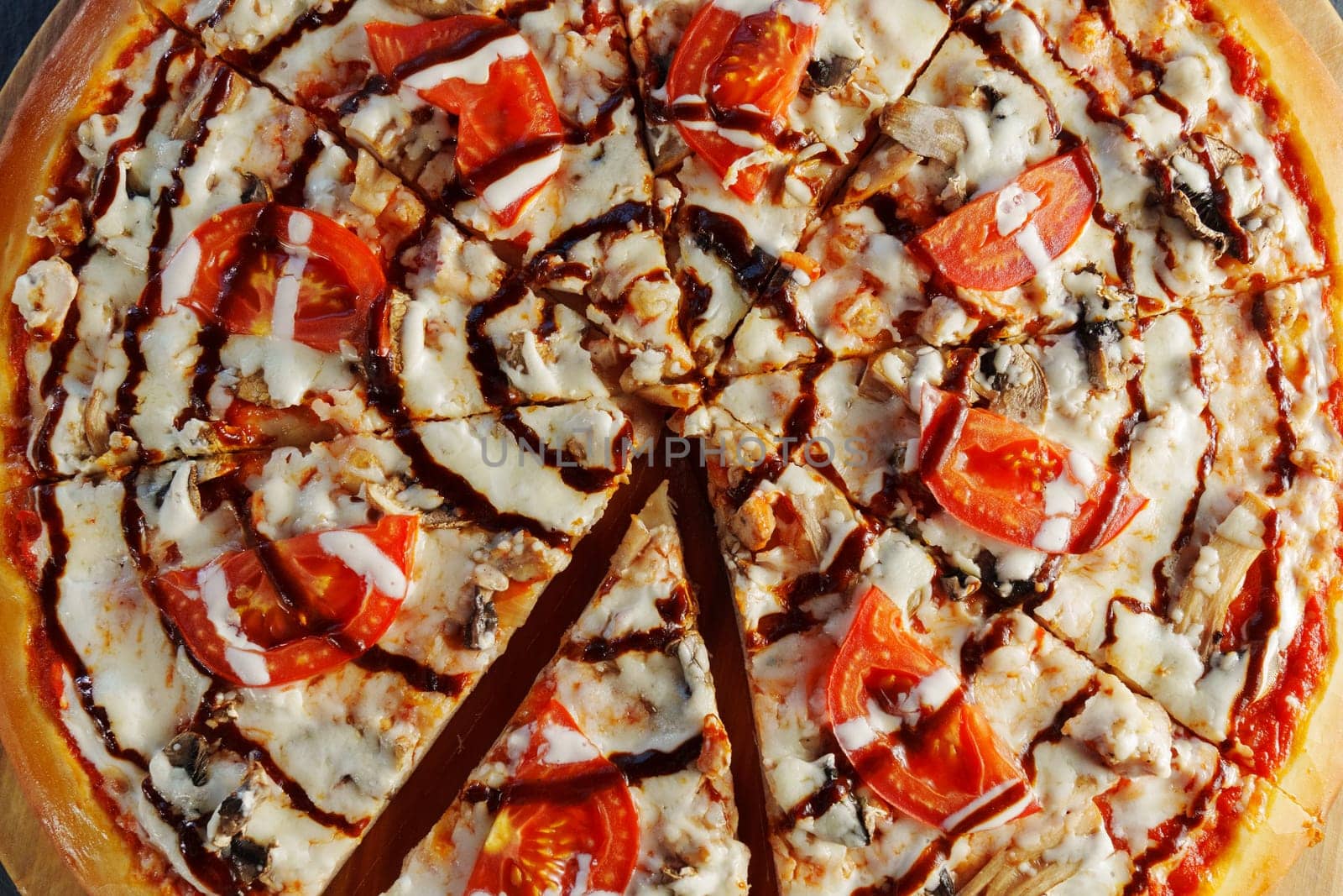 Mouthwatering pepperoni pizza adorned with vibrant tomatoes and black olives rests on a rustic wooden board, inviting all to savor its cheesy goodness during a cozy meal.