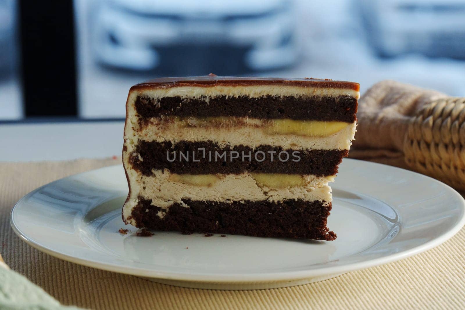 Layers of rich chocolate cake interspersed with velvety cream frosting create a tantalizing dessert experience, perfect for any celebration or indulgence.