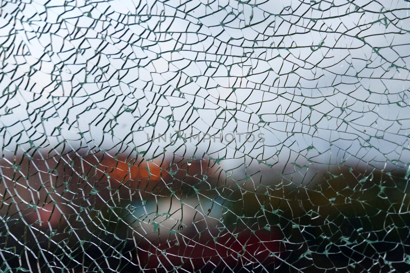 Delicate shards of broken glass create a mesmerizing texture, softening the view of a colorful