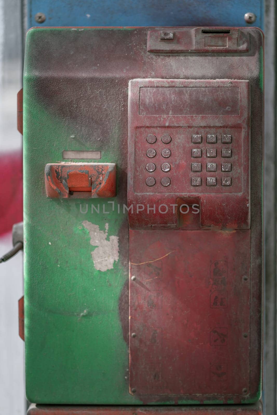 Abandoned vintage public coin operated public payphone. Old public service coin telephone in thailand that is no longer used due to technological advances, Copy space, Selective focus.