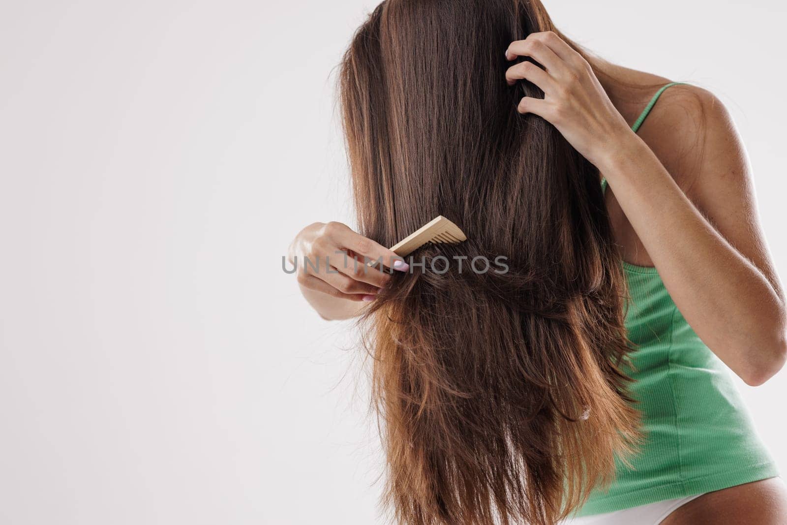 Beauty Hair Care. Beautiful Woman Combing Long Natural Hair, hair care, hair problem