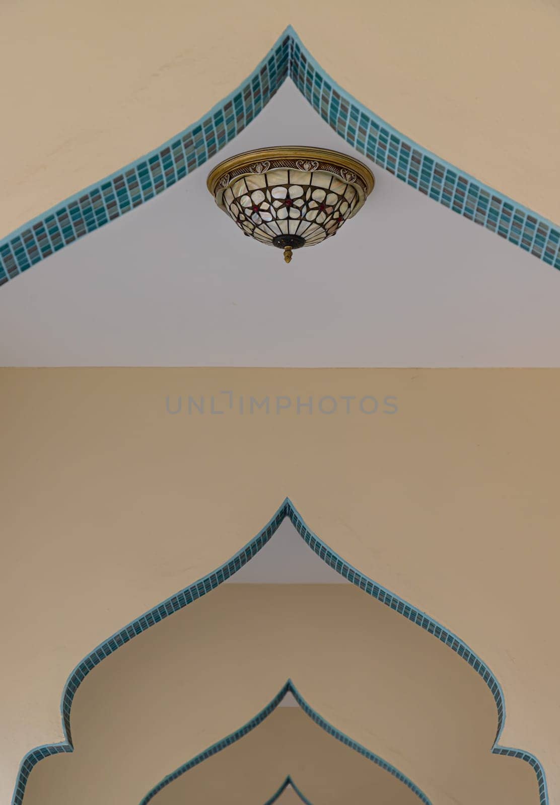 Bangkok, Thailand - May 28,2022 - Leading lines or curve of interior design elements with Ceiling lamp of Bang O mosque. Perspective architecture and art concept, Space for text, Selective focus.