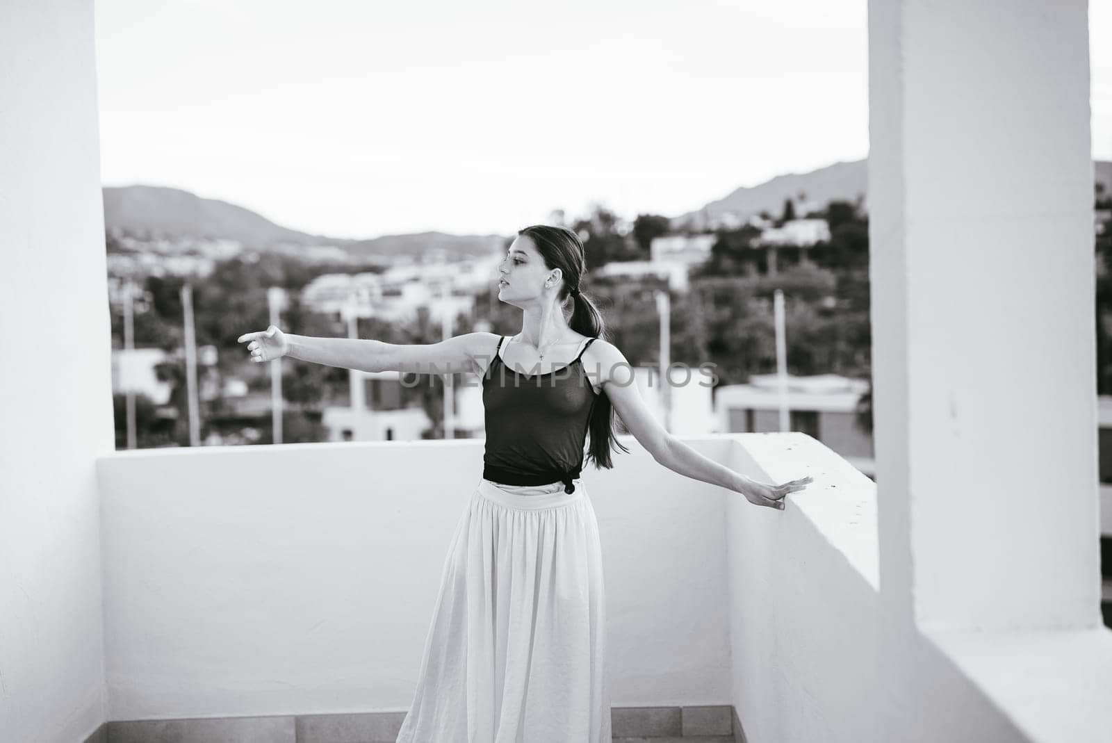 A beautifully serene capture of a graceful dancer in dynamic motion on a balcony, showcasing both elegance and beauty