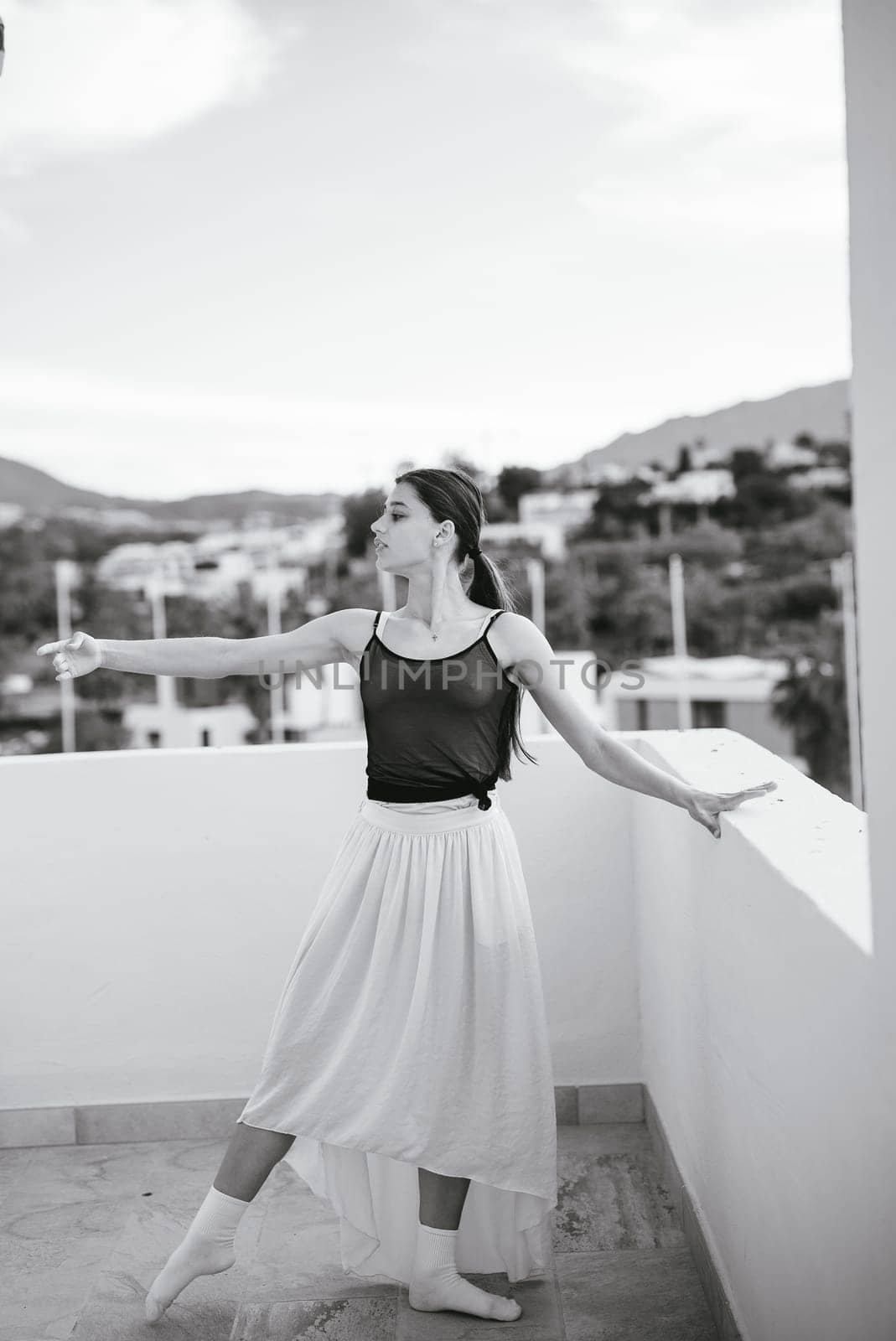 An elegant dancer displays the art of movement and deep expression against a stunning scenic backdrop