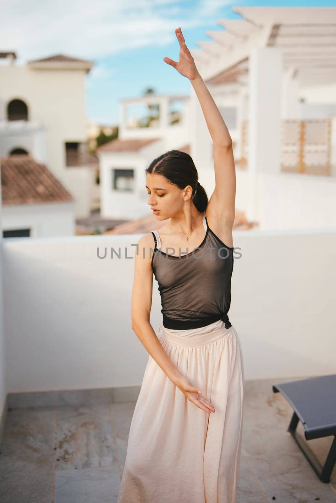 A graceful dancer elegantly showcases her artistry and skill against a vibrant and contemporary backdrop