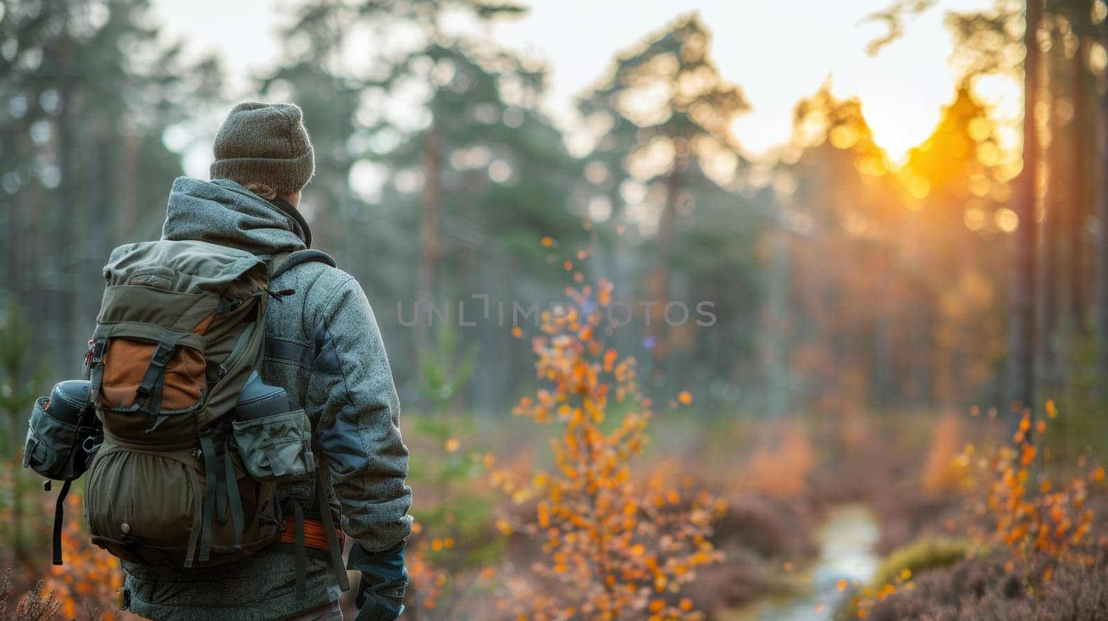 A young traveler with a backpack on a hike. Hiking in the fall forest . Tourist traveler against the background of the forest.