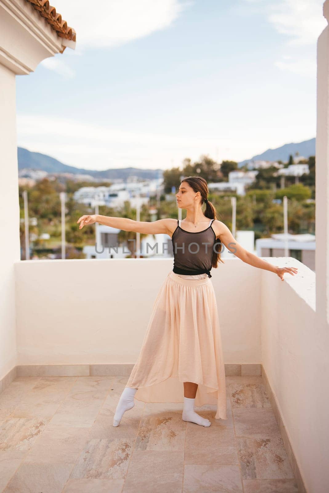 A graceful and elegant ballerina strikes a stunning pose against a gorgeous scenic backdrop of nature