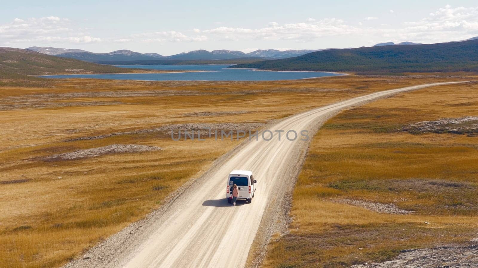 Two individuals in a car, admiring stunning ocean views as the sun sets, creating a warm and picturesque atmosphere on their journey.
