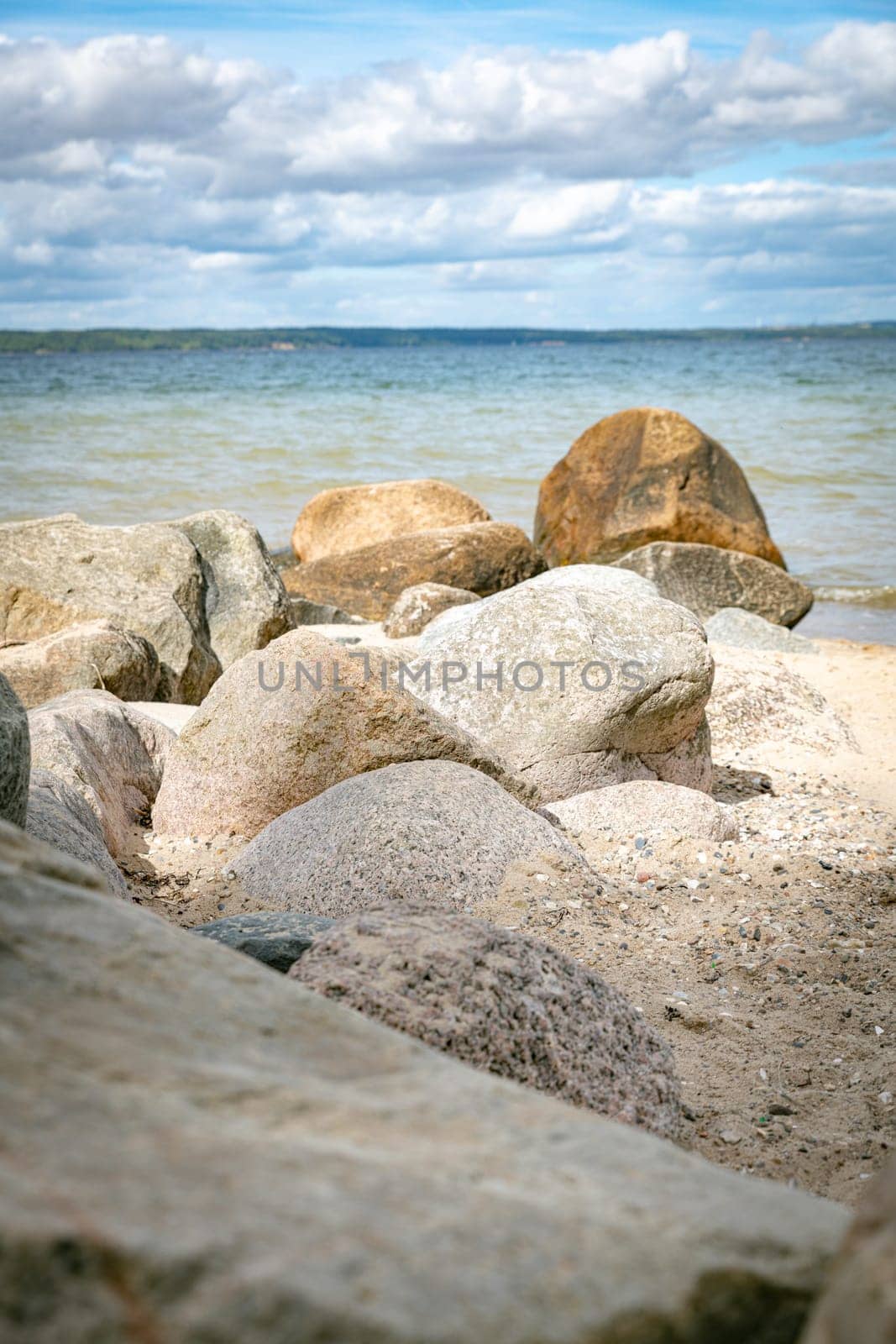 beach with rochs in denmark trelde naes at the kattegat water
