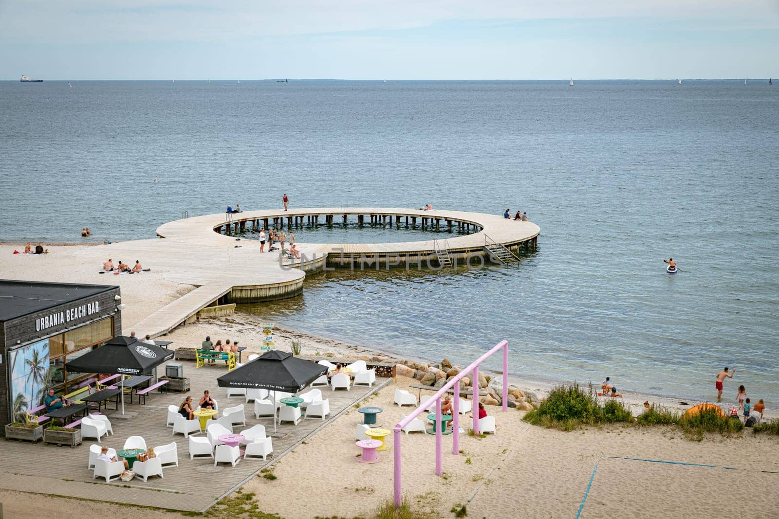 Fredericia, Jutland, Denmark, July 25, 2024 - Sandy beach at the city coastline with people enjoy the summer and sun