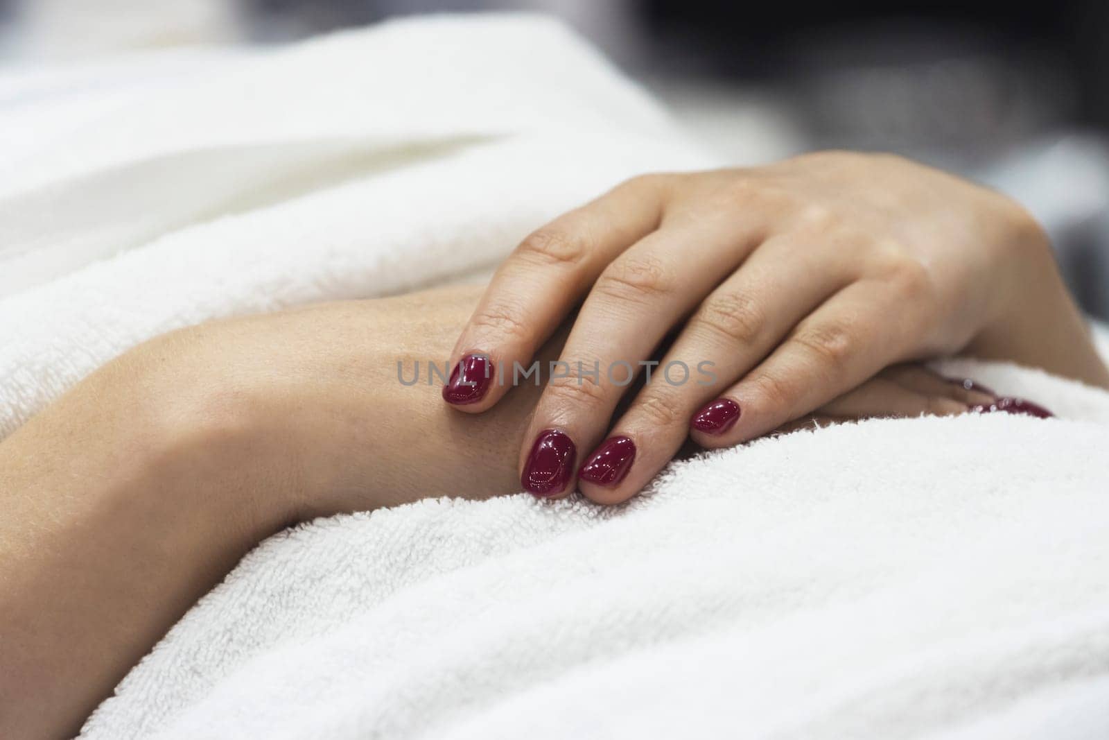 girl folded her hands at the beautician , close-up