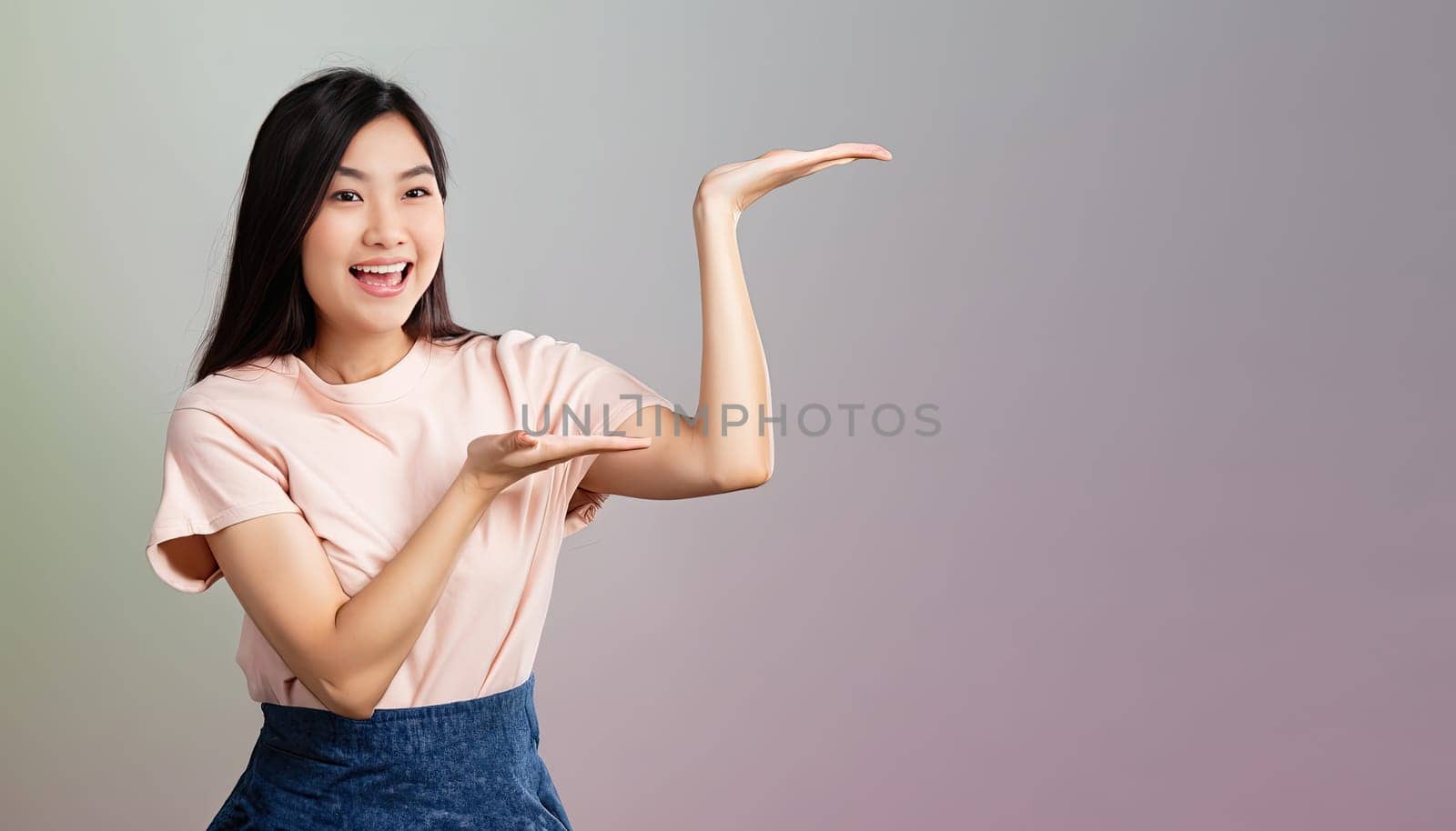 Portrait of young beautiful Asian lady smiling with cheerful expression, shows something amazing at blank space banner background poster wallpaper. AI Generative. by Benzoix